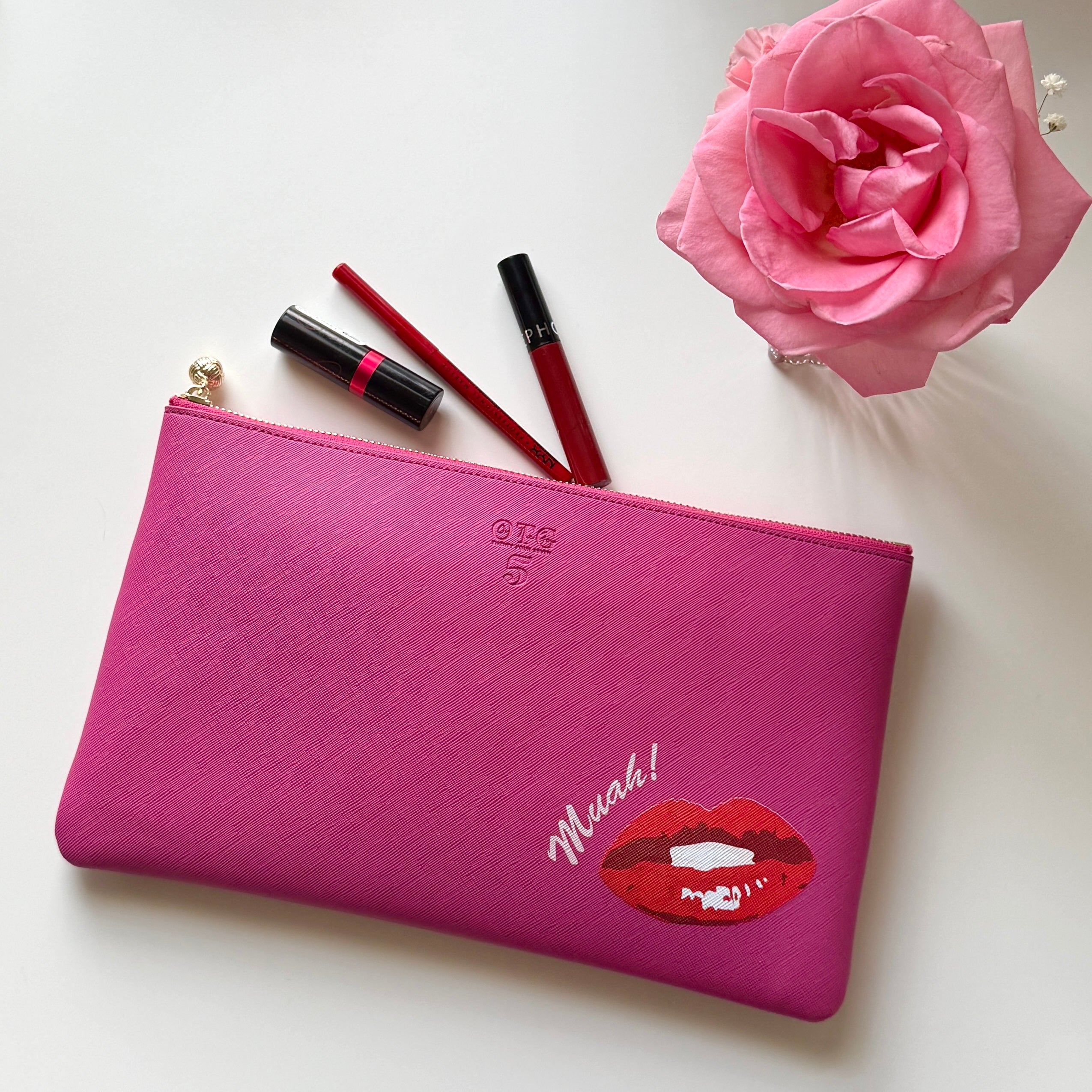 #5 Hot Pink Viv Lips Clutch styled flat with red lipstick, lip liner and a pink rose